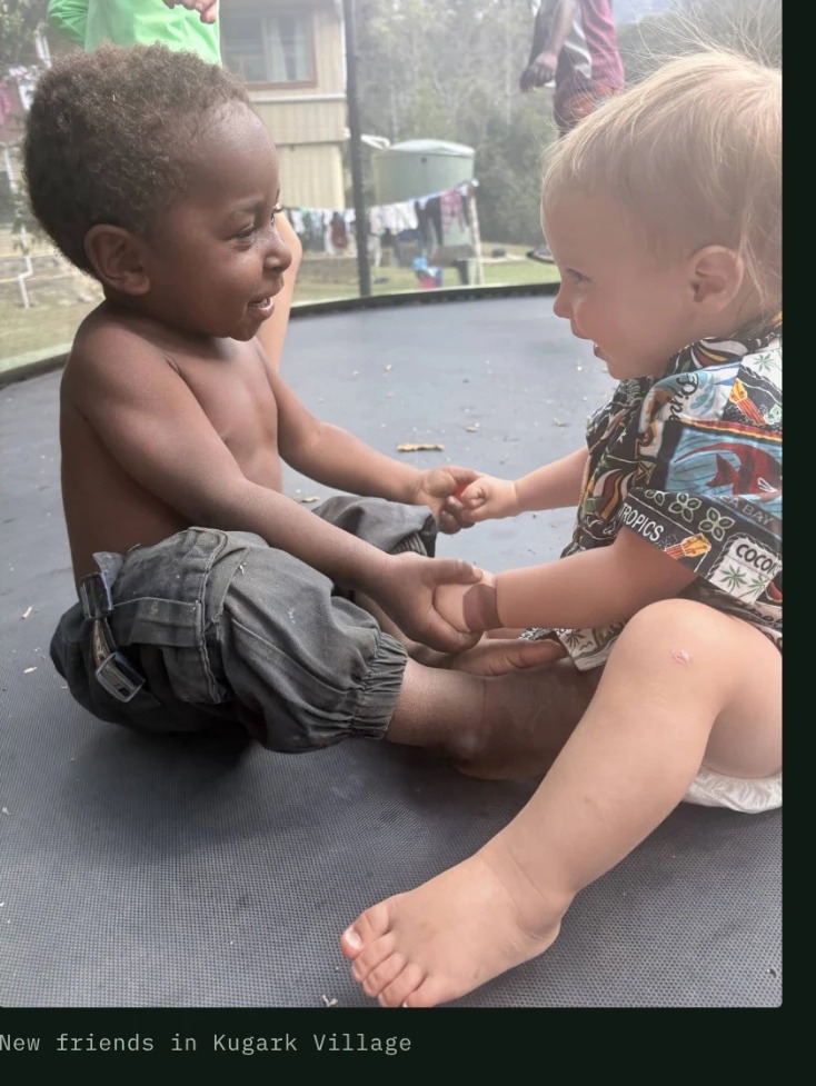 Curtis visiting with a child from the Kugark Village community